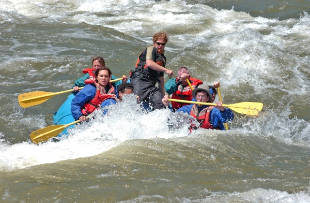 People wearing red buoyancy aids during their rafting race
