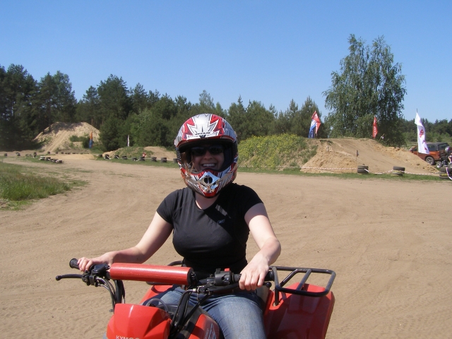 Woman wearing white and red helmet during her quad session
