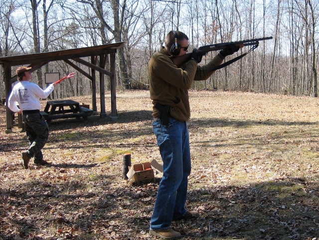 Man wearing brown sweater shooting
