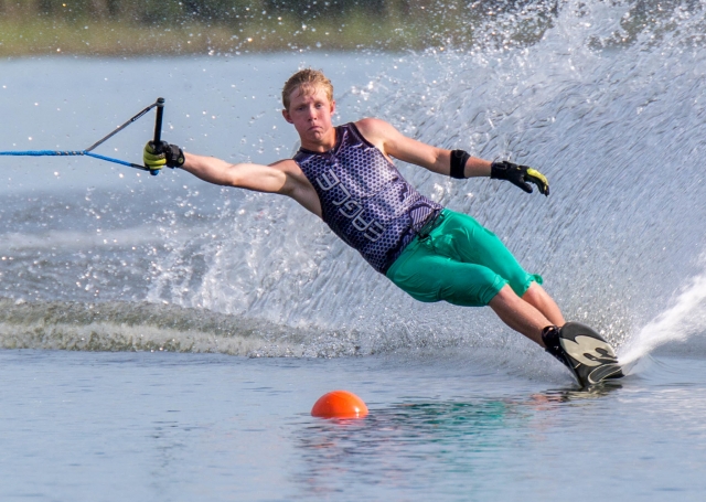 Girl wearing purple buoyancy aids doing water skiing