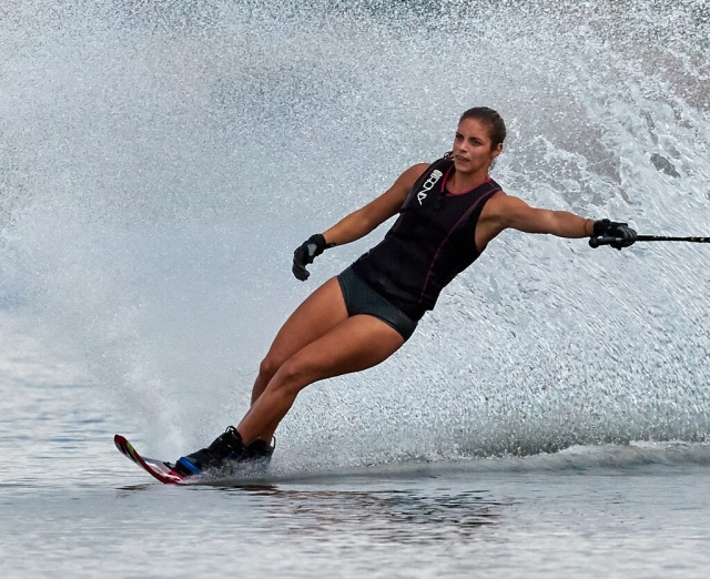 Woman wearing black buoyancy aids water skiing
