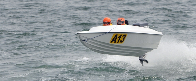 White powerboat and two people learning how to control the boat