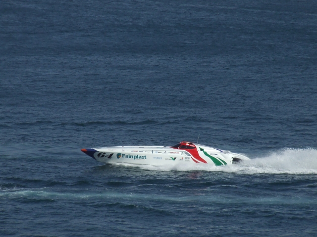 White powerboat and people learning how to handle it