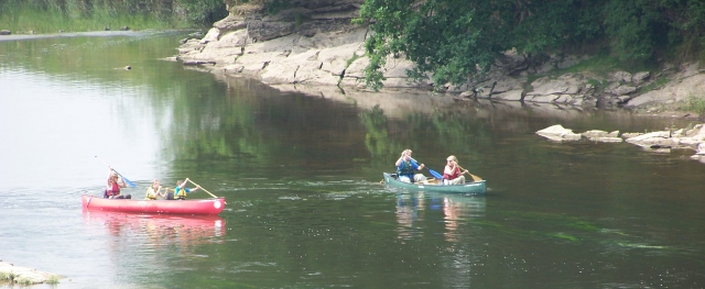 Canoes by rocks