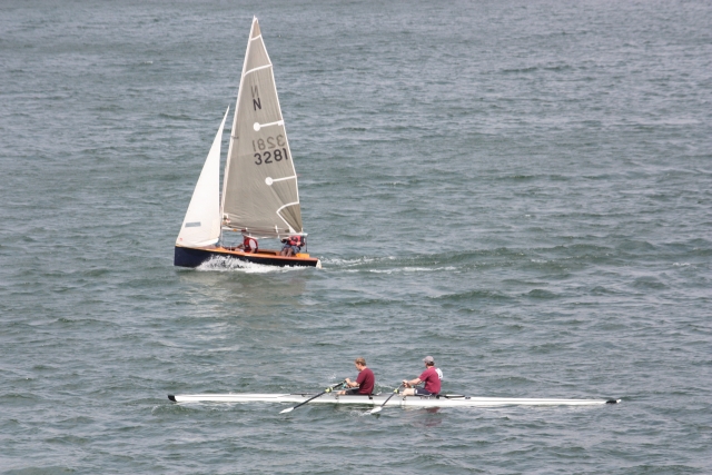  Sailing with rowers passing by 