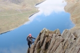 Lead climbing over crystal clear water