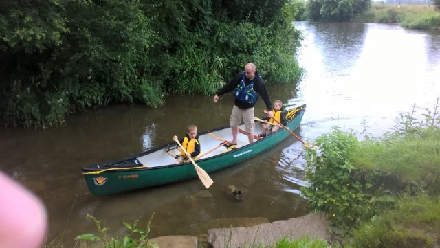 Family padlding a canoe