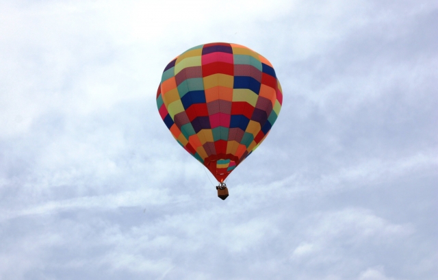 Colourful balloon flying high over Dorset