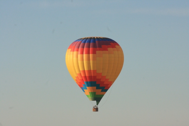 Yellow, orange and blue balloon flying over Dorset