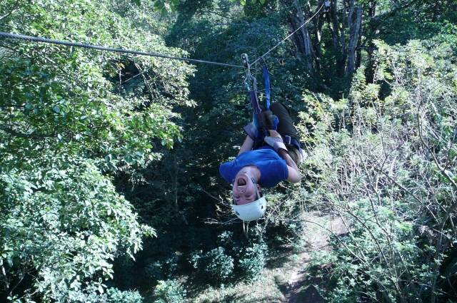 Girl screaming and having fun during her zip-lining experience