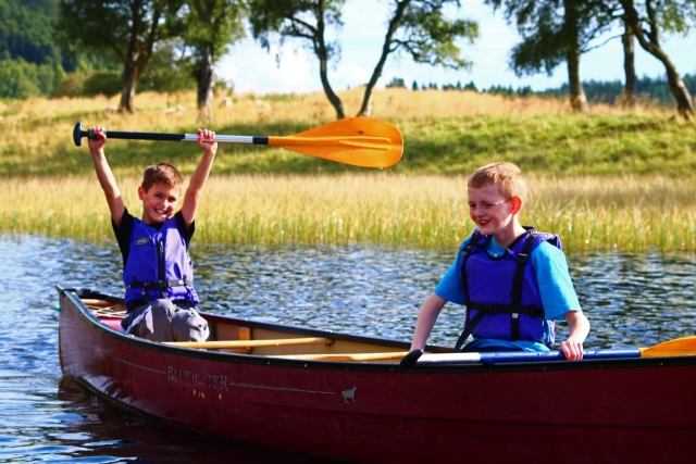 e-19759610-two-kids-wearing-blue-t-shirts-smiling-and-canoeing16436143548286.jpg