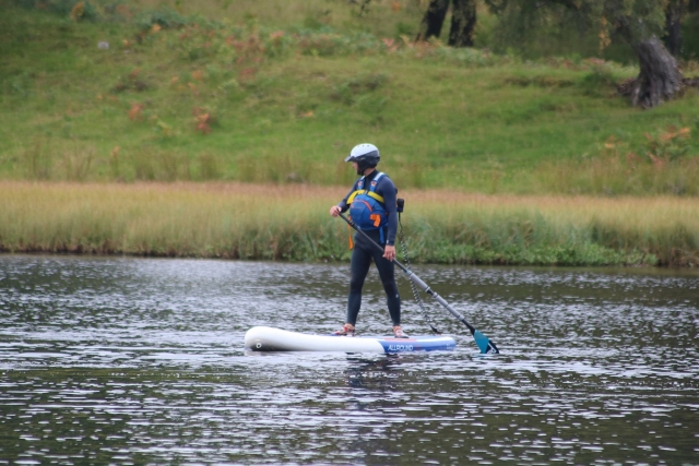 e-19759611-boy-wearing-blue-wetsuit-and-blue-buoyancy-aids-paddleboarding-and-forest-at-the-backfround16436153876054.jpg