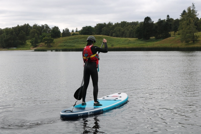 e-19759611-girl-wearing-red-buoyancy-aids-and-black-helmet-paddleboarding16436153865845.jpg