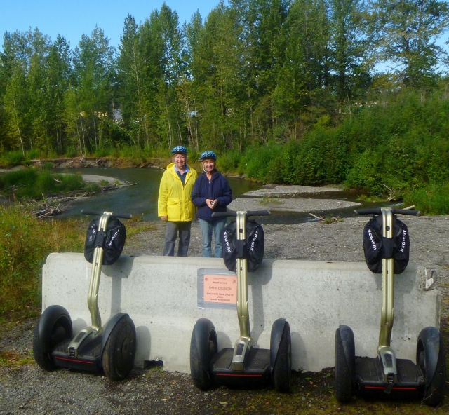 Two friends smiling, wearing blue helmets, about to enjoy their segway session
