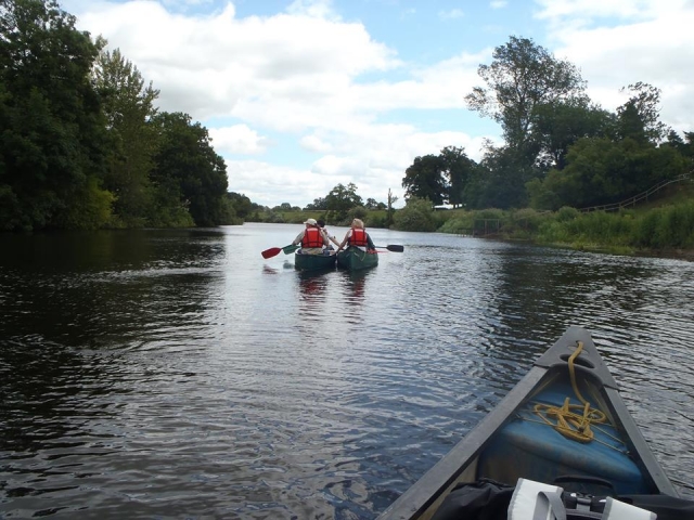 Camp by the riverside and canoe during the day