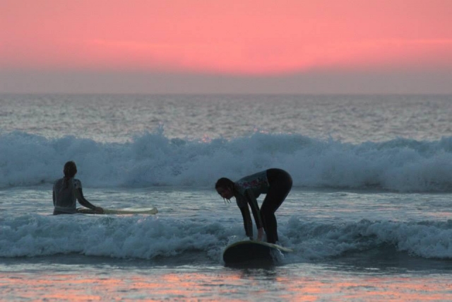 Surfing at sunset