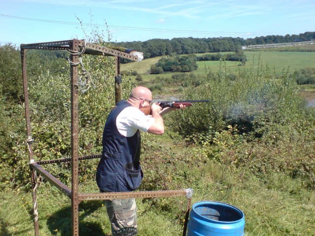 man practising clay shooting