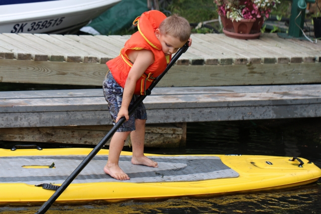 Kid trying  Paddle boarding