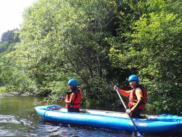 Couple having fun kayaking in Great Glen