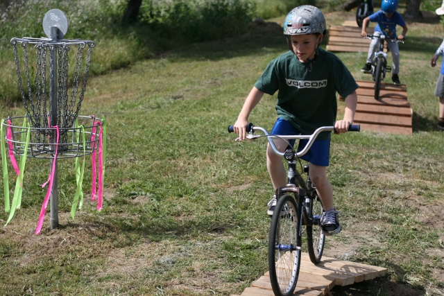 Young boy mountain biking with us