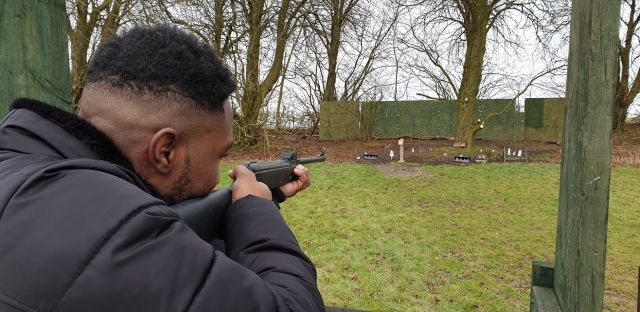 Man in black jacket rifle shooting