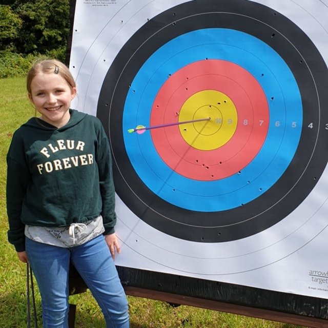  Ragazza che sorride mentre fa tiro con l'arco (1) 