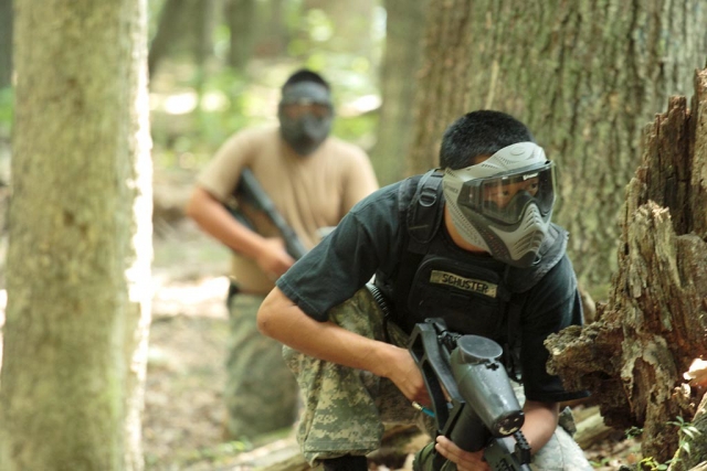  Hombre de negro jugando paintball a punto de recibir un disparo 