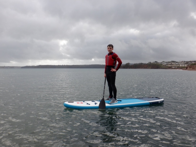 p-73997-boy-in-red-buoyancy-aids-and-black-wetsuit-about-to-start-his-paddleboarding-session_16418095066136.jpg