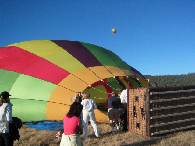 A colourful ballong about to take off