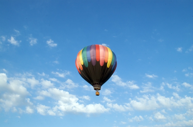 Colourful balloon flying on the blue sky