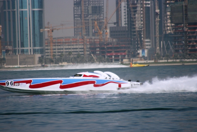 Powerboating at the harbour on a red, blue and white powerboat