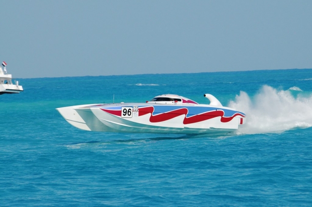 Powerboating on white, blue and red powerboat