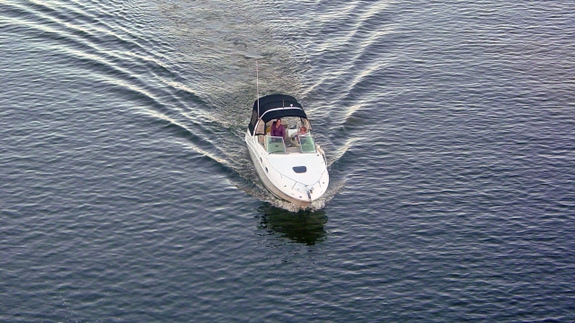 White powerboat and adventurers learning how to drive it