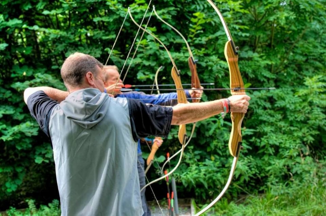 Three men doing archery