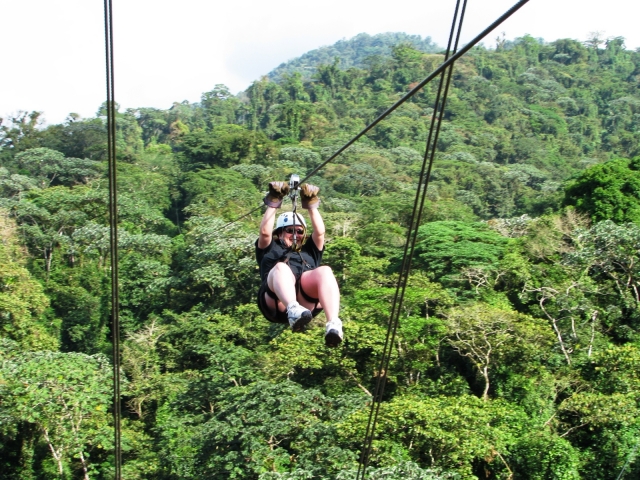 Boy wearing white helmet and black t-shirt during his zip-lining session