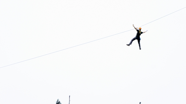 Man wearing black t-shirt during his zip-lining experience
