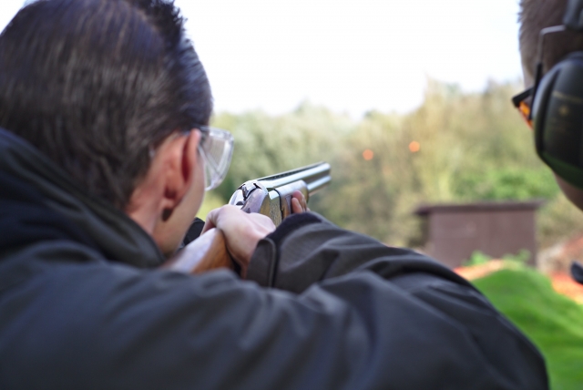 Man wearing black sweater clay pigeon shooting