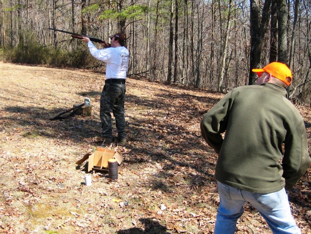 Man in white shooting in the forest