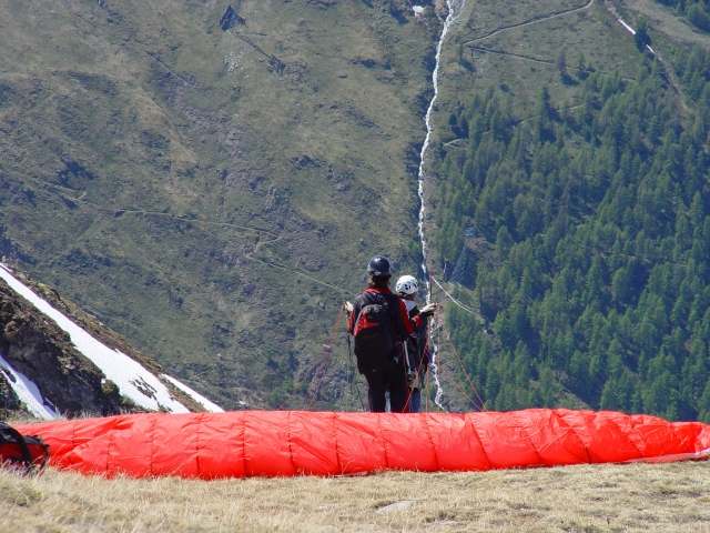 Boy and girl hugging watching the view after paragliding session