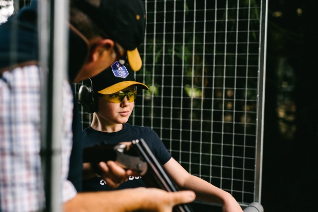 Child on his first clay pigeon shooting experience